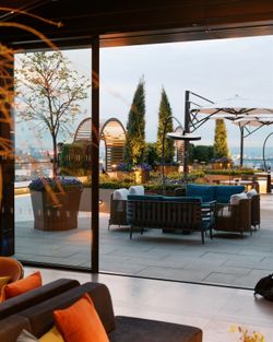 Manhattan rooftop event space with cozy seating, decorative plants, and panoramic city views at Le Jardin sur Madison.