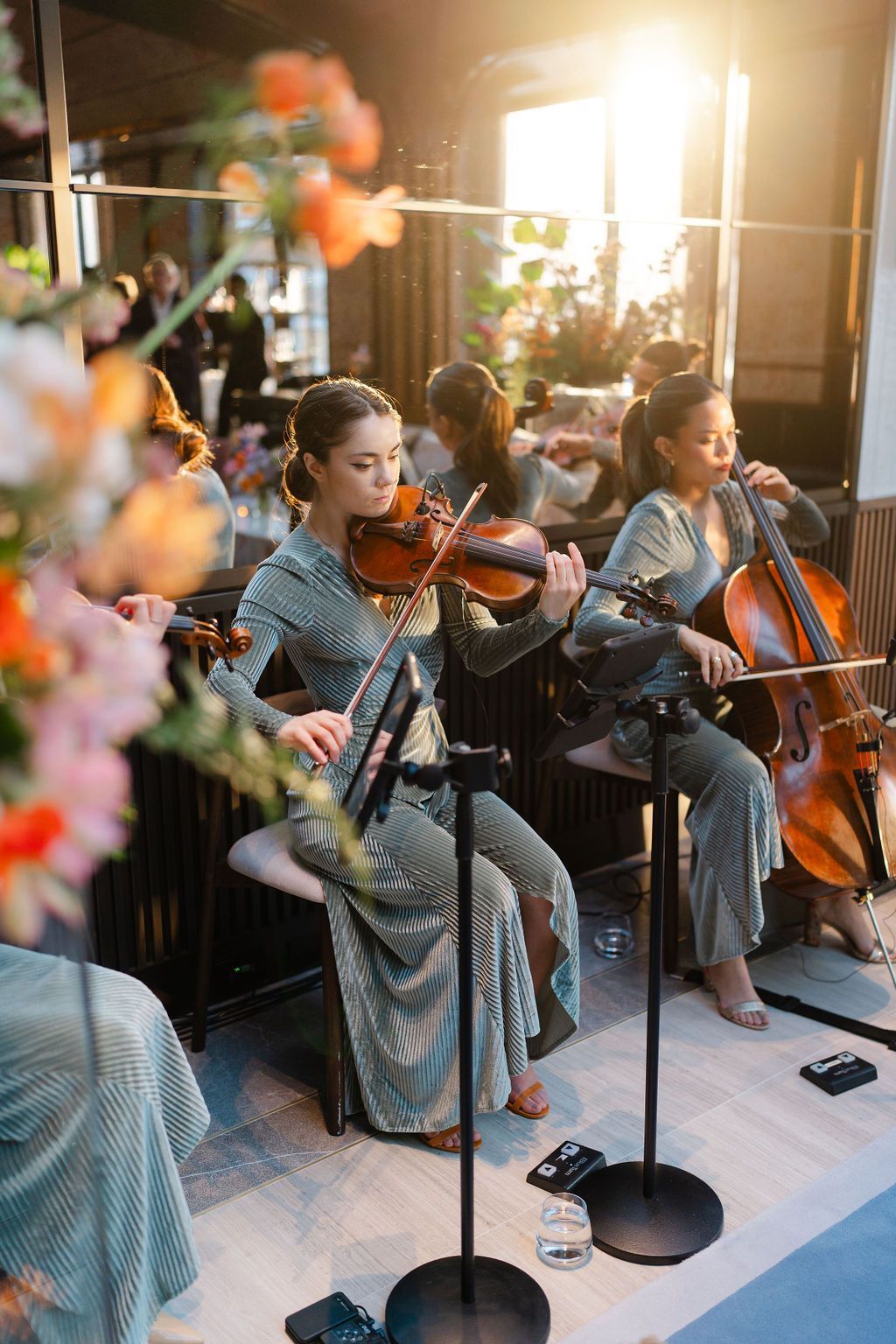 Elegant musicians performing at Le Jardin sur Madison, showcasing the rooftop event space with floral decor.