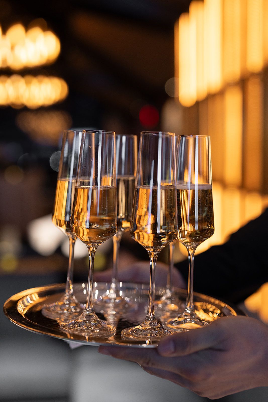A tray of champagne flutes filled with bubbly, reflecting the elegant ambiance of Le Jardin sur Madison.
